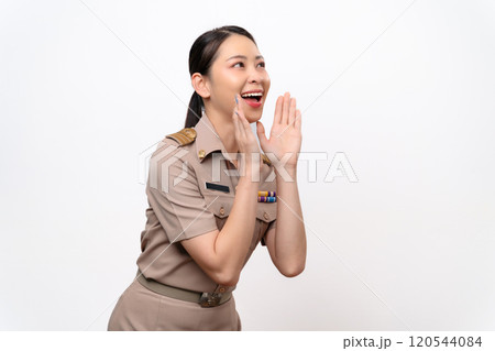 Young Thai Asian Teacher in the uniform hands up to the mouth for announcement 120544084