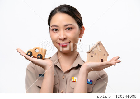 Young Thai Asian Teacher in the uniform is holding wooden house and car toy Young Thai Asian Teacher in the uniform is holding wooden house and car toy 120544089