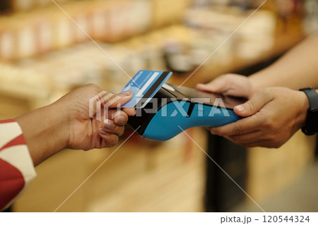 Swiping Credit Card on Modern Payment Terminal Swiping Credit Card on Modern Payment Terminal 120544324