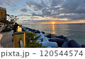 北谷の海と夕日とテトラポット 120544574