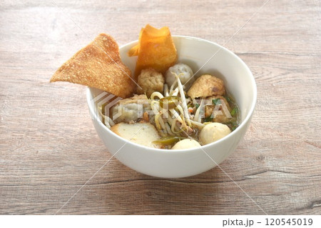 boiled Hakka meatball made from chop pork stuffing fried tofu with bean sprout and fish ball  topping crispy dumpling in spicy tom yum soup on bowl 120545019