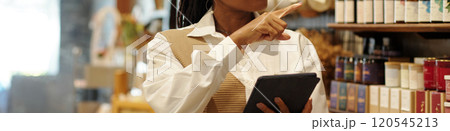 Smiling Woman Choosing Wine in Vineyard Shop Smiling Woman Choosing Wine in Vineyard Shop 120545213