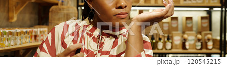 Woman Enjoying Aromas in a Cozy Store Environment Woman Enjoying Aromas in a Cozy Store Environment 120545215