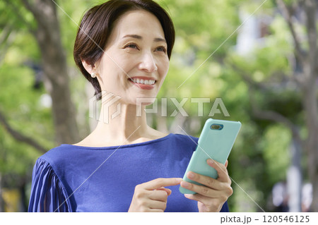 公園でスマホを持つ女性 公園でスマホを持つ女性 120546125