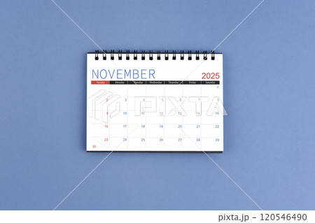 November 2025 Monthly desk calendar for 2025 year on blue background. Flat lay. November 2025 Monthly desk calendar for 2025 year on blue background. Flat lay. 120546490