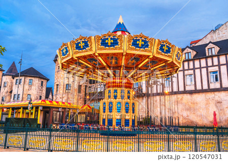 Festive chain carousel on the square of medieval city in Europe 120547031