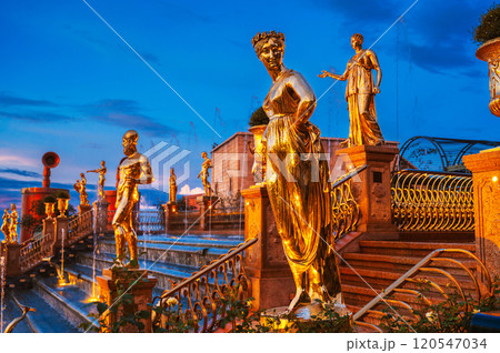 Antique golden statues on cascade of fountains in Ba Na Hills Park in Da Nang in Vietnam at evening 120547034