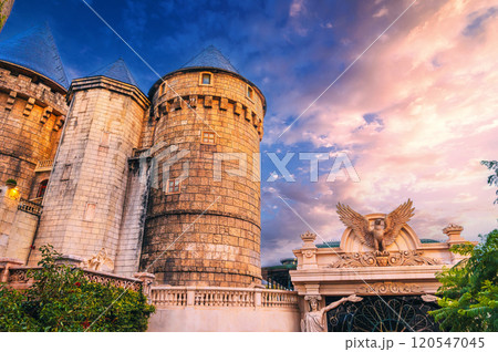Stone tower of medieval European castle fortress at sunset 120547045