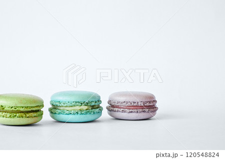 Row of three colorful French Macarons, macaroons cakes with different flavors Row of three colorful French Macarons, macaroons cakes with different flavors 120548824