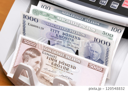 Old Icelandic money in a counting machine 120548832