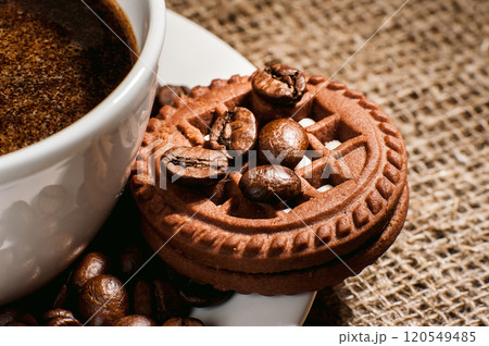 Cup of coffee with smoke and coffee beans on burlap on old wooden background.Cup of coffee with smoke and coffee beans on burlap on old wooden background Cup of coffee with smoke and coffee beans on burlap on old wooden background.Cup of coffee with smoke and coffee beans on burlap on old wooden background 120549485