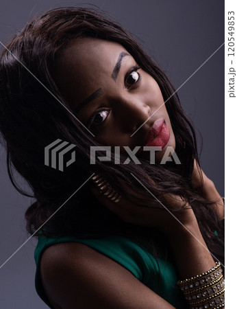 Portrait of a cheerful young woman. Beautiful african american girl with afro hairstyle smiling Portrait of a cheerful young woman. Beautiful african american girl with afro hairstyle smiling 120549853
