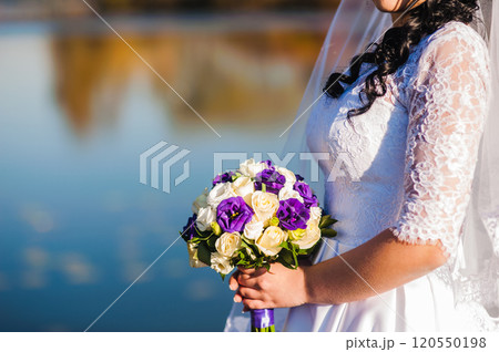 The bride with a wedding bouquet of roses The bride with a wedding bouquet of roses 120550198