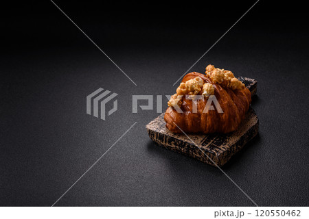 Sweet crispy croissant with salted caramel and glazed popcorn Sweet crispy croissant with salted caramel and glazed popcorn 120550462