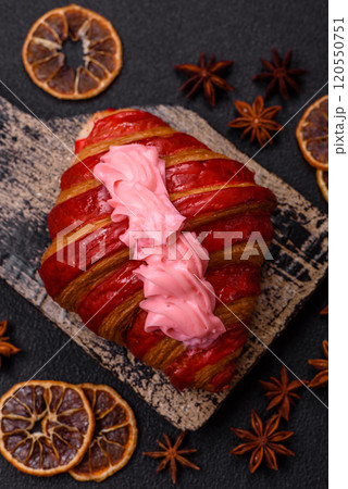 Crispy fresh red croissant with cream and strawberries Crispy fresh red croissant with cream and strawberries 120550751