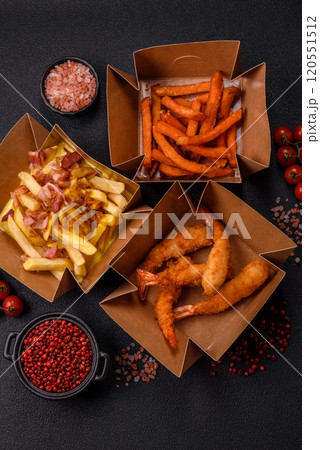 Crispy French fries with pieces of bacon, salt and spices Crispy French fries with pieces of bacon, salt and spices 120551512