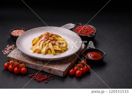 Crispy French fries with pieces of bacon, salt and spices Crispy French fries with pieces of bacon, salt and spices 120551533