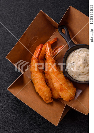 Hot crispy shrimp breaded with salt and spices with white sauce 120551613