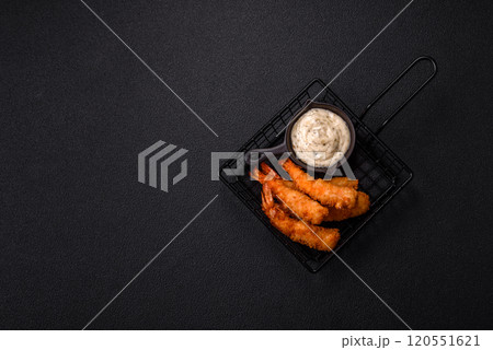 Hot crispy shrimp breaded with salt and spices with white sauce 120551621