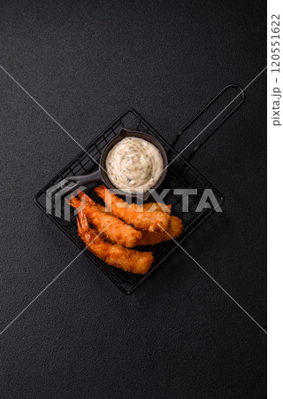 Hot crispy shrimp breaded with salt and spices with white sauce 120551622