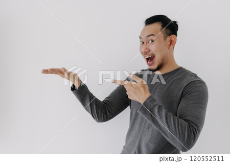 Wow surprise face man in grey fleece base layer offer present on white. Wow surprise face man in grey fleece base layer offer present on white. 120552511