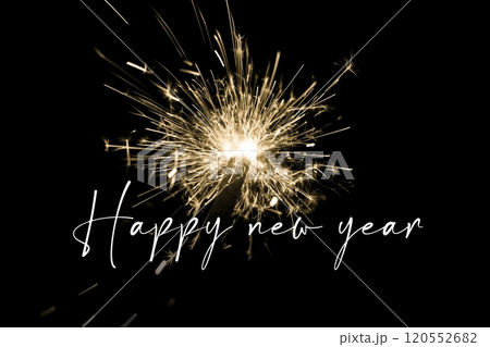 Happy new year yellow sparkler new years eve countdown. Luxury entertainment celebration turn of the year party time. Premium nightlife visual with glowing light sparks on dark background. 120552682