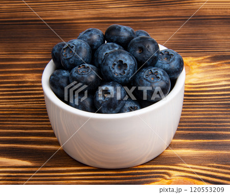 Fresh blueberry in white dish on wooden background Fresh blueberry in white dish on wooden background 120553209