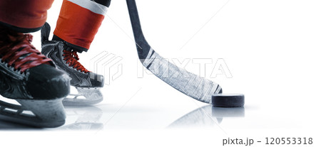 Hockey skates, puck and stick close-up. Hockey player in ice rink. Focus on the puck. Isolated. Hockey concept 120553318