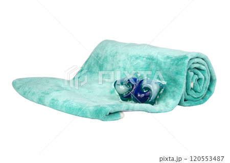 Colorful gel washing capsule on green fabric isolated on the white background 120553487