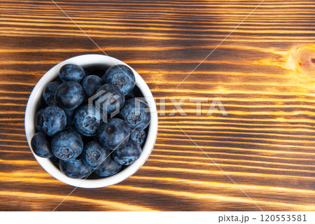 Fresh blueberry in white dish on wooden background Fresh blueberry in white dish on wooden background 120553581