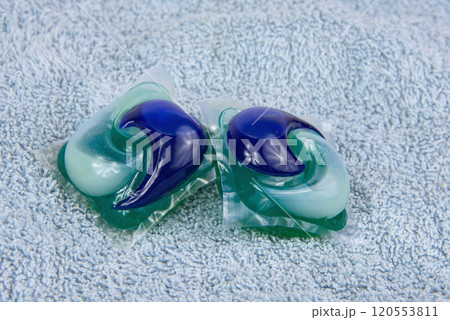 Colorful gel capsule for washing on blue material soft background Colorful gel capsule for washing on blue material soft background 120553811