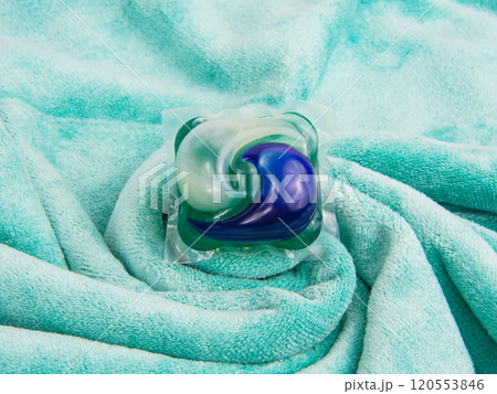 Colorful gel capsule for washing on blue green material soft background Colorful gel capsule for washing on blue green material soft background 120553846