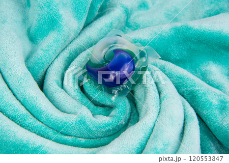 Colorful gel capsule for washing on blue green material soft background Colorful gel capsule for washing on blue green material soft background 120553847