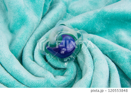 Colorful gel capsule for washing on blue green material soft background Colorful gel capsule for washing on blue green material soft background 120553848