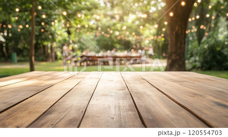 An empty wooden table with a garden party 120554703