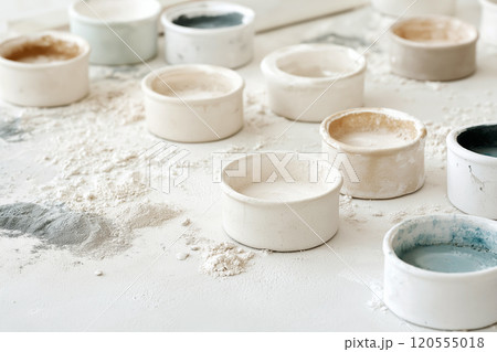 An art studio with scattered canvases, pastel chalks, and acrylic paints, creating a sense of creative chaos An art studio with scattered canvases, pastel chalks, and acrylic paints, creating a sense of creative chaos 120555018