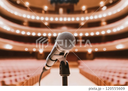 Microphone on a stand with blurred lights in the background 120555609