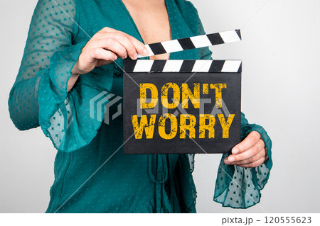Do not worry. Female hands holding movie clapper 120555623