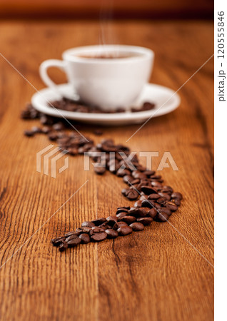 Coffee beans and a cup of coffee.cup of coffee and beans on dark background, top view Coffee beans and a cup of coffee.cup of coffee and beans on dark background, top view 120555846