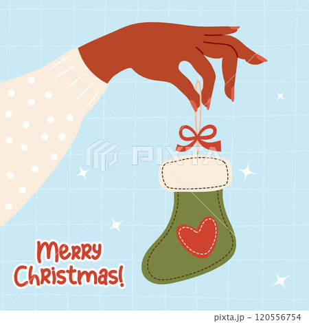Female dark-skinned hand holding Christmas handmade sewn toy green stocking on light blue checkered background. Vector illustration. Holiday Xmas, New Year card 120556754