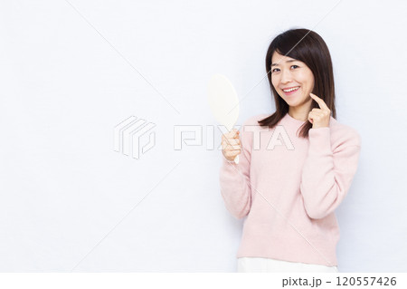 お肌をチェックするミドル女性 120557426