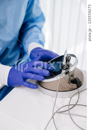 Dentist using advanced touch screen equipment for dental treatment with precision tools Dentist using advanced touch screen equipment for dental treatment with precision tools 120559273