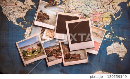 A collage of polaroid photos on a world map, evoking travel memories 120559349