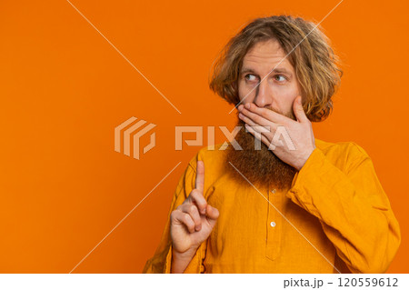 Frightened young man closing mouth with hands refusing to tell terrible secret unbelievable truth 120559612