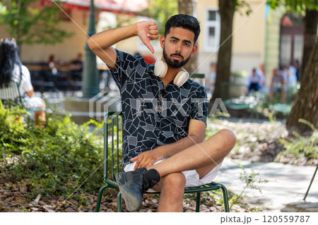 Indian man showing thumbs down dislike sign gesture disapproval, dissatisfied bad work, mistake Indian man showing thumbs down dislike sign gesture disapproval, dissatisfied bad work, mistake 120559787