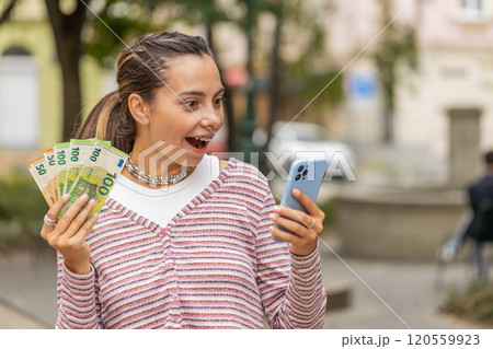 Happy woman counting money euro cash, use smartphone calculator app in urban city street Happy woman counting money euro cash, use smartphone calculator app in urban city street 120559923