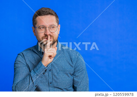 Man presses finger to lips make silence gesture sign do not tells secret stop gossip privacy 120559978