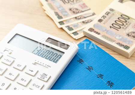 130万と表示された電卓と年金手帳 120561489