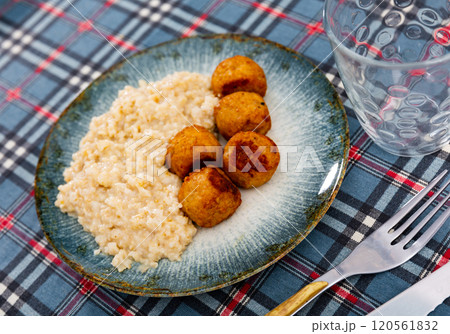 Oatmeal served with meatballs on plate Oatmeal served with meatballs on plate 120561832