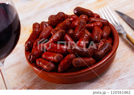 Traditional spanish hot sausage chistorritas on skewers closeup Traditional spanish hot sausage chistorritas on skewers closeup 120561962
